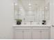 Bright bathroom features a double sink vanity, large mirror, and white cabinets for storage and a clean, modern aesthetic at 9510 E Theia Dr, Mesa, AZ 85212