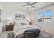 Serene main bedroom features a ceiling fan, a neutral color palette, and ample natural light at 9510 E Theia Dr, Mesa, AZ 85212