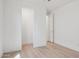 Bright bedroom featuring wood-look floors, overhead lighting, and an open closet door at 9510 E Theia Dr, Mesa, AZ 85212