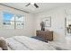 Comfortable bedroom features a large window, a ceiling fan, and stylish decor at 9510 E Theia Dr, Mesa, AZ 85212