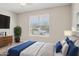 Bright bedroom featuring a ceiling fan, large window, and tasteful decor for a serene living space at 9510 E Theia Dr, Mesa, AZ 85212