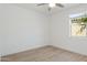 Bright bedroom features wood-look floors, ceiling fan, and window with natural light at 9510 E Theia Dr, Mesa, AZ 85212