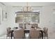 Bright dining area features a modern chandelier and a large window for plenty of natural light at 9510 E Theia Dr, Mesa, AZ 85212