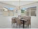 Bright dining area with marble floors, elegant table setting, and ample natural light from large windows at 9510 E Theia Dr, Mesa, AZ 85212