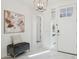 Inviting foyer boasts marble floors, an upholstered bench, and a modern light fixture, offering a stylish welcome at 9510 E Theia Dr, Mesa, AZ 85212