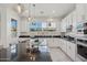Open kitchen features an island with bar seating and bright white cabinetry at 9510 E Theia Dr, Mesa, AZ 85212