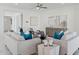Bright living room featuring modern sofas, stylish decor, and an open layout for seamless entertaining and relaxation at 9510 E Theia Dr, Mesa, AZ 85212
