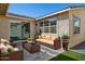 Inviting outdoor patio with wicker furniture, manicured landscaping, and plenty of room to relax at 9510 E Theia Dr, Mesa, AZ 85212