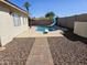 A private backyard featuring a path to the pool with slide and diving board, set against a desert-scape at 9612 N 52Nd Dr, Glendale, AZ 85302