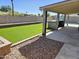 Backyard with artificial turf, desert landscaping, and outdoor built in kitchen at 9612 N 52Nd Dr, Glendale, AZ 85302