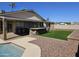 Beautiful backyard with pool, turf, outdoor kitchen, and desert landscaping at 9612 N 52Nd Dr, Glendale, AZ 85302