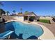 Expansive backyard featuring a sparkling pool with slide, outdoor kitchen, and artificial turf at 9612 N 52Nd Dr, Glendale, AZ 85302