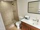 Bathroom with a tiled shower, a sink with a vanity, and modern fixtures at 9612 N 52Nd Dr, Glendale, AZ 85302