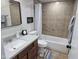 Bathroom with a vanity sink, toilet and bath-tub with shower and tile surround at 9612 N 52Nd Dr, Glendale, AZ 85302