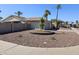 Inviting single-story home showcasing desert rock landscaping, mature palm trees, and a convenient two car garage at 9612 N 52Nd Dr, Glendale, AZ 85302