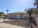 Charming single-story home featuring desert rock landscaping, a two car garage and healthy palm trees at 9612 N 52Nd Dr, Glendale, AZ 85302