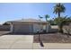 Charming single-story home with a well-maintained landscape, desert rock, and mature trees in the front yard at 9612 N 52Nd Dr, Glendale, AZ 85302