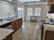Bright kitchen featuring wood cabinets, granite countertops, and tile floors at 9612 N 52Nd Dr, Glendale, AZ 85302