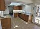 Well-lit kitchen featuring wood cabinets, granite countertops, tile floors, and modern appliances at 9612 N 52Nd Dr, Glendale, AZ 85302