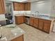 Modern kitchen with wood cabinets, granite countertops and stainless steel dishwasher at 9612 N 52Nd Dr, Glendale, AZ 85302
