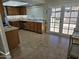 Bright eat-in kitchen with tile floors, wood cabinets, granite countertops, and stainless steel appliances at 9612 N 52Nd Dr, Glendale, AZ 85302
