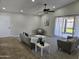 Sun-lit living room featuring neutral walls, plush carpet, stylish furnishings, and sliding glass doors to the yard at 9612 N 52Nd Dr, Glendale, AZ 85302
