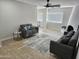Inviting living room featuring comfortable seating, a ceiling fan, and stylish tile floors at 9612 N 52Nd Dr, Glendale, AZ 85302