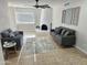 Inviting living room showcasing light neutral walls, tiled floors, fireplace, stylish sofas and decor at 9612 N 52Nd Dr, Glendale, AZ 85302
