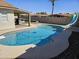 An inviting backyard pool with a slide, complemented by a built-in BBQ and lush landscaping at 9612 N 52Nd Dr, Glendale, AZ 85302