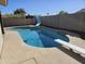 A refreshing backyard pool featuring a slide and diving board, set against a sunny backdrop at 9612 N 52Nd Dr, Glendale, AZ 85302