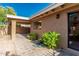 A cozy backyard showcasing a tiled patio, desert landscaping, and neutral tones at 1010 E Lois Ln, Phoenix, AZ 85020