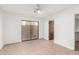 Neutral bedroom features a ceiling fan, closet and a sliding door to the outside at 1010 E Lois Ln, Phoenix, AZ 85020