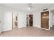 Bright bedroom features a ceiling fan, closet and entrance to the bathroom at 1010 E Lois Ln, Phoenix, AZ 85020