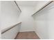 Well-lit walk-in closet with white shelving and tile flooring at 1010 E Lois Ln, Phoenix, AZ 85020