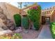 Landscaped courtyard area with mature trees and flowering bushes, offering a private outdoor space at 1010 E Lois Ln, Phoenix, AZ 85020