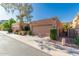 Single-story home with a two-car garage, featuring privacy landscaping and manicured shrubbery at 1010 E Lois Ln, Phoenix, AZ 85020