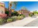 Charming single-story home with a two-car garage, enhanced by mature trees and vibrant floral accents at 1010 E Lois Ln, Phoenix, AZ 85020