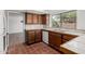 Kitchen featuring wood cabinetry and neutral tile countertops at 1010 E Lois Ln, Phoenix, AZ 85020