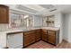 Kitchen with wood cabinets, tile counters, and garden window at 1010 E Lois Ln, Phoenix, AZ 85020
