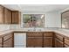 Close up of kitchen countertops with stainless steel sink and tile backsplash at 1010 E Lois Ln, Phoenix, AZ 85020