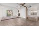 Bright open-concept living room with tile flooring, large windows and unique architectural elements at 1010 E Lois Ln, Phoenix, AZ 85020