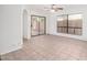 Bright and airy living room with neutral tile flooring, sliding glass doors and a ceiling fan at 1010 E Lois Ln, Phoenix, AZ 85020