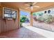 Charming covered patio with tiled flooring, a ceiling fan, and a serene view of the landscaped backyard at 1010 E Lois Ln, Phoenix, AZ 85020