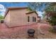 Well-maintained backyard with mature landscaping, a fire pit area, and pavers leading to the covered patio at 10811 W Avenida Del Rey --, Peoria, AZ 85383