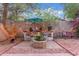 Cozy backyard showcasing a charming outdoor dining area with string lights, potted plants, and pavers at 10811 W Avenida Del Rey --, Peoria, AZ 85383
