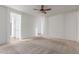 A clean bedroom with neutral carpet, a ceiling fan, and easy access to other rooms in the home at 10811 W Avenida Del Rey --, Peoria, AZ 85383