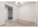 Bedroom with neutral carpet, ceiling fan, and a view into another room in the home at 10811 W Avenida Del Rey --, Peoria, AZ 85383