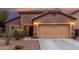Charming stucco home with a two-car garage and desert landscaping at dusk at 10811 W Avenida Del Rey --, Peoria, AZ 85383