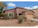 Close up of single-story home with desert landscaping and a two-car garage in a Gathering-friendly neighborhood at 10811 W Avenida Del Rey --, Peoria, AZ 85383