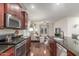 Stylish kitchen showcasing granite countertops, stainless steel appliances, and an open view to the living room at 10811 W Avenida Del Rey --, Peoria, AZ 85383